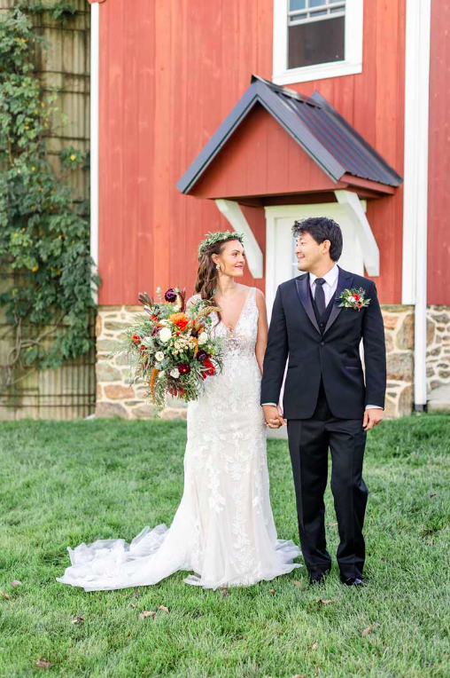 Couple getting married outside of a barn